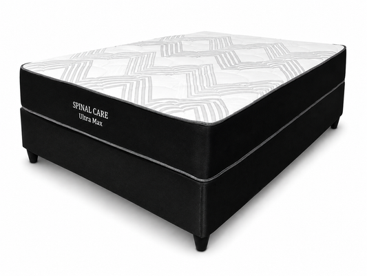 A box spring mattress with a black upholstered base and a white mattress topper featuring a gray geometric pattern, shown on a white background. The side of the mattress base is labeled 'SPINAL CARE Ultra Max'.